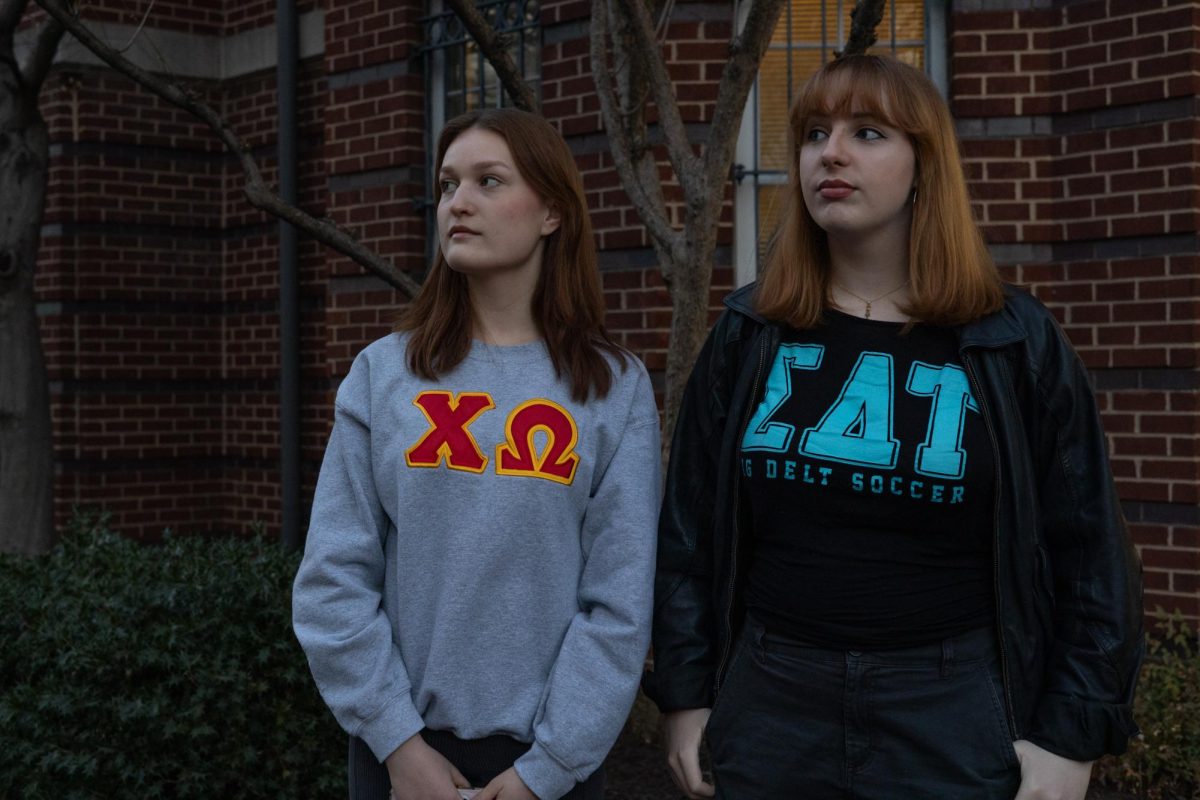 GW Panhellenic President Anastasia Adams and Executive Vice President Charlotte McCourt pose for a portrait in front of Townhouse Row on 23rd Street. 