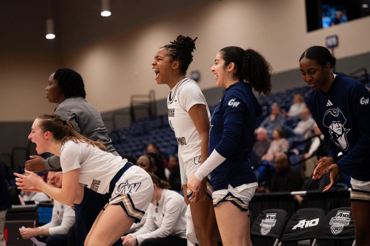 Senior forward Maxine Engel, sophomore forward Sara Lewis and junior guard Natalie Sierra-Vargas yell from the sidelines during today's game against Loyola. 