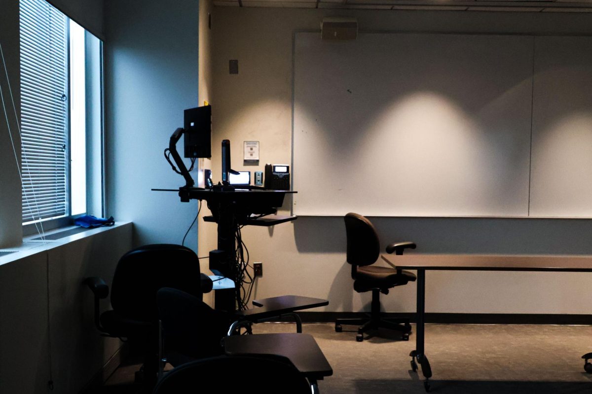 Lights shine down on an empty classroom podium.