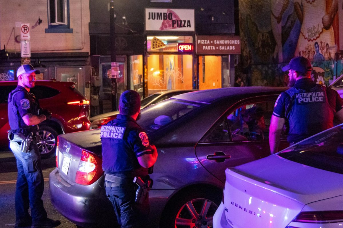 Metropolitan Police Department officers conduct a traffic stop on U Street NW on Friday amid increased federal law enforcement presence in D.C.