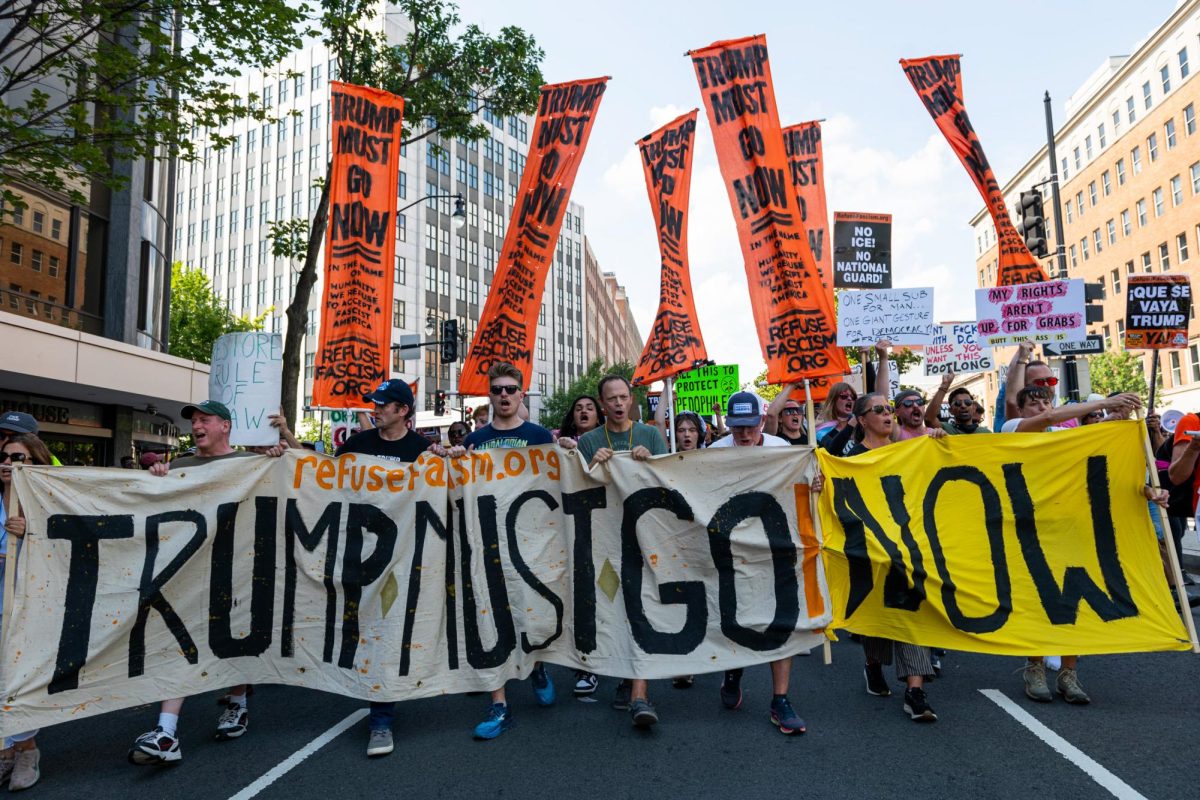 Demonstrators march from DuPont Circle to the White House Saturday, protesting President Donald Trump's deployment of federalized troops in the city.