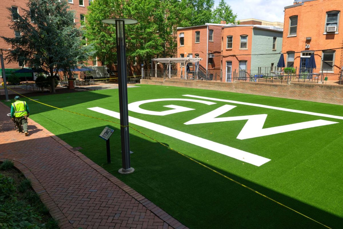 A construction worker walks next to the newly renovated Square 80 turf.