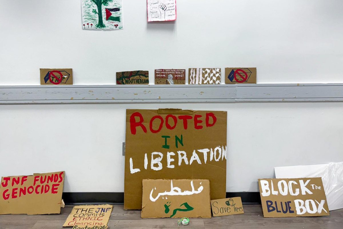 Signs made by students rest against the wall in the University Student Center during a a event hosted by Jewish Voice for Peace in February.
