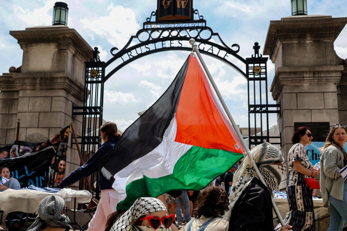 Pro-Palestinian demonstrators wave a flag in front of the Trustees Gate in Kogan Plaza this April.