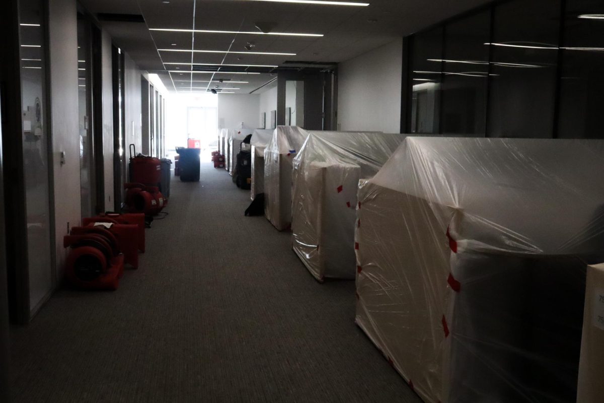 Desks are wrapped up in a hallway of the Science and Engineering Hall after flooding.