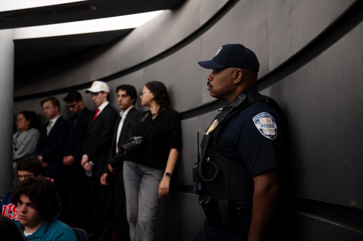 A GW Police Department officer stands during GW College Republicans' vigil for Charlie Kirk on Wednesday night.
