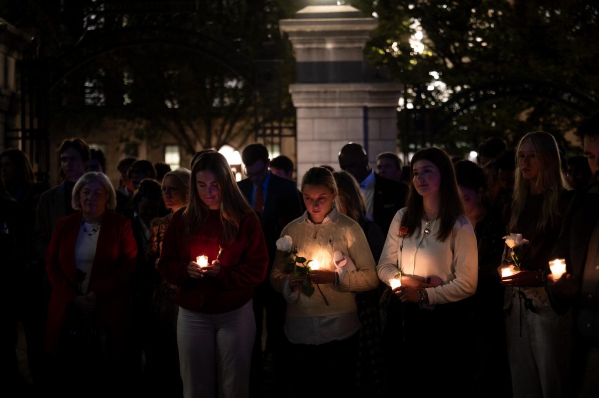 University President Ellen Granberg, left, and students attend a vigil for Charlie Kirk in Kogan Plaza.  