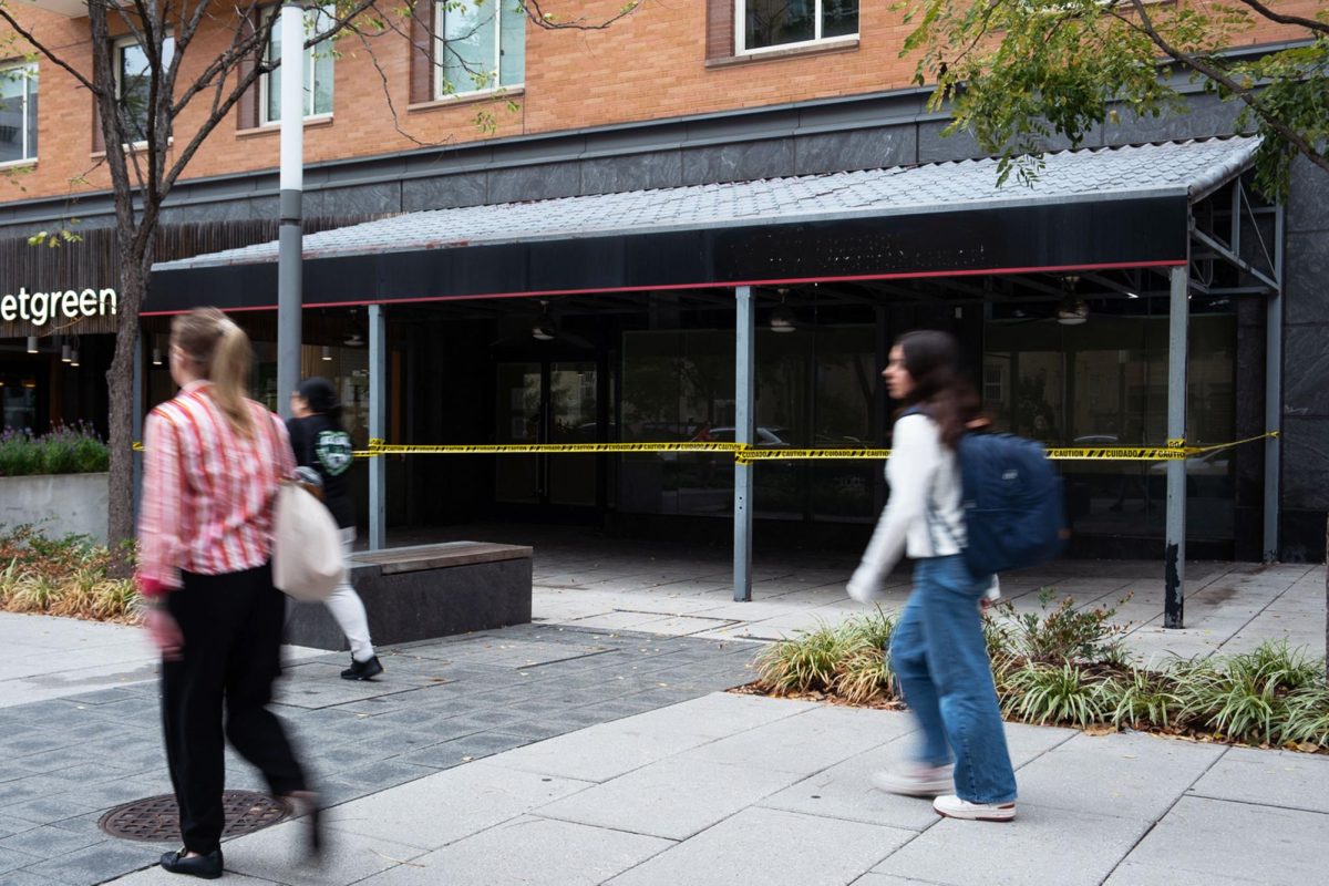 People walk in front of the old Roti building, which is now in lease to become Cava.