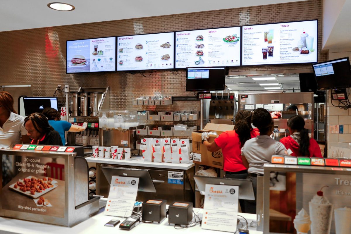 Workers prepare orders at the new Chick-Fill-A beneath Mitchell Hall Tuesday.