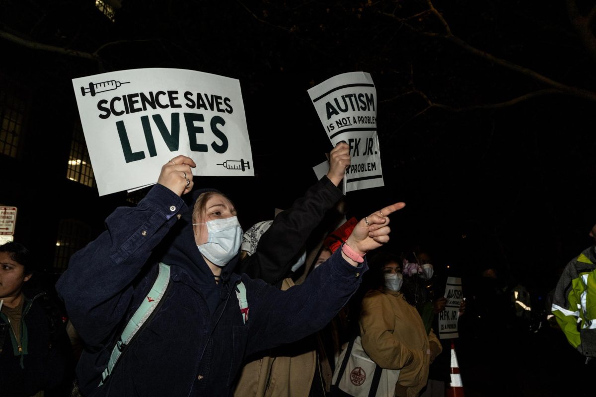 Students chant outside of Lisner Auditorium at the protest on Monday.