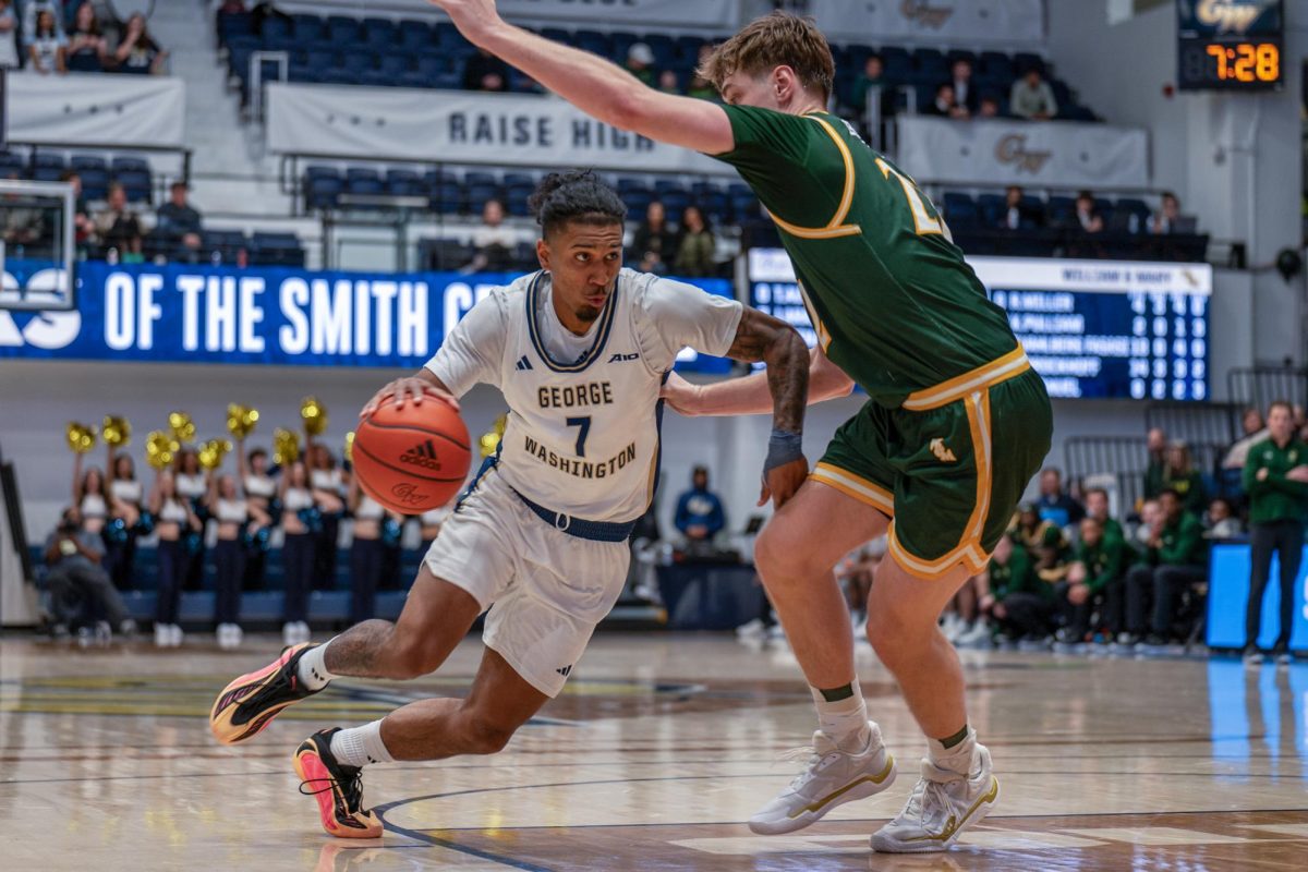 Junior guard Jean Aranguren dribbles toward the hoop during Saturday's game against the College of William & Mary.