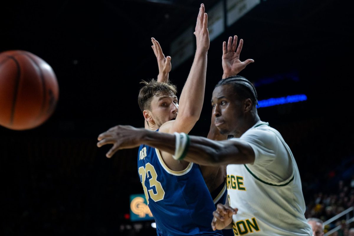 Graduate forward Luke Hunger attempts to block a George Mason pass during their January game.