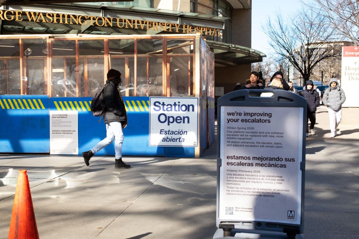 A sign announcing ongoing construction on the escalators is displayed at the Foggy Bottom-GWU Metro Station.