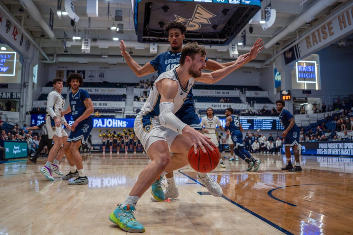 Graduate forward Luke Hunger dribbles the ball during Tuesday's game against Rhode Island.