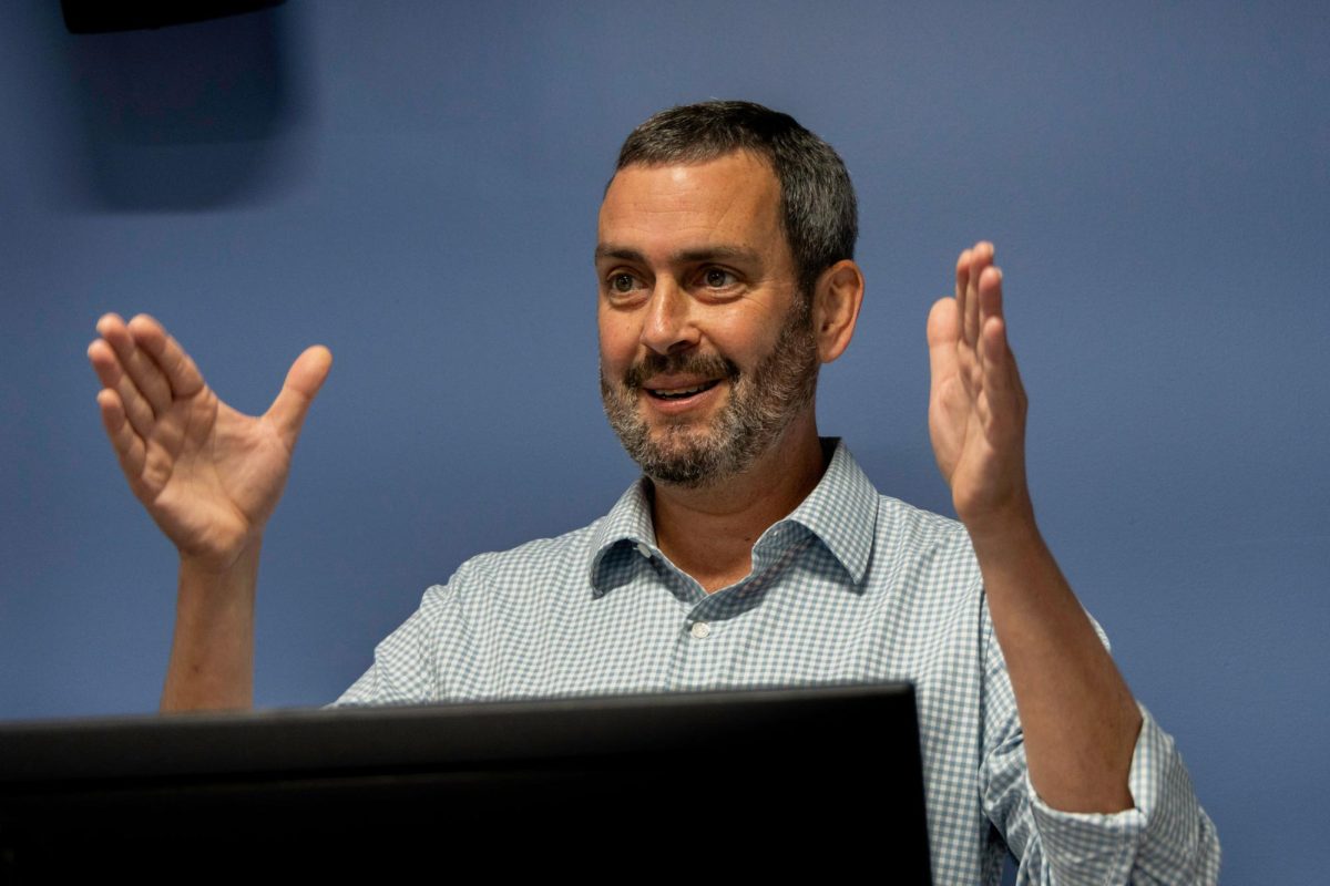 Chris Horton, a freelance journalist, presents on his book “Ghost Nation" on Monday.