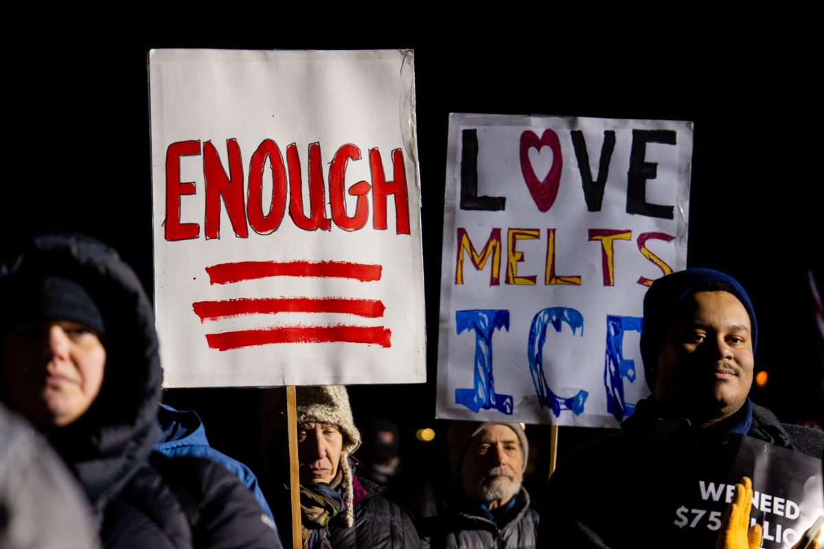 Onlookers hold up signs during the People's State of the Union held infront of Capitol Hill on Tuesday.