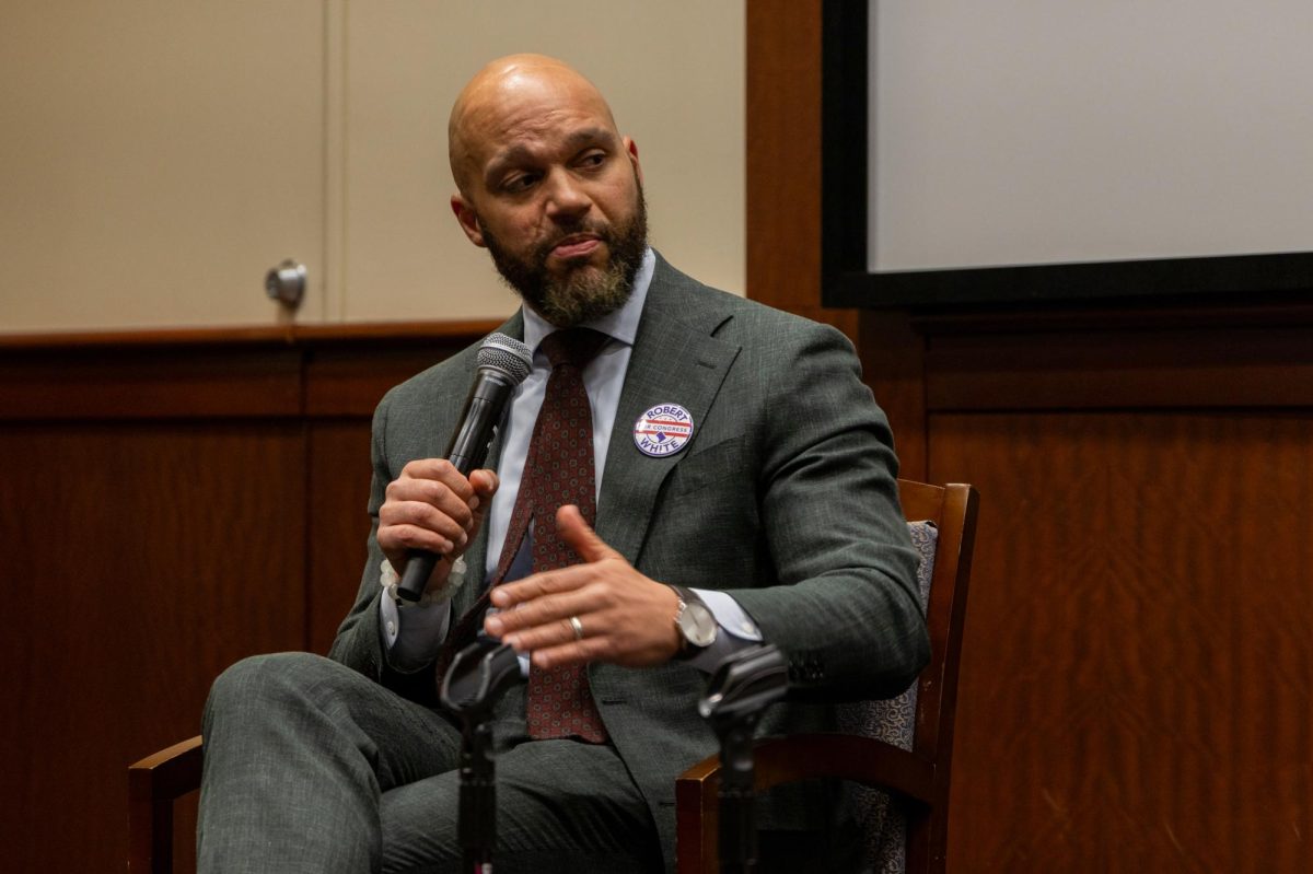 At-large Council member Robert White speaks at a forum in the University Student Center on Tuesday.