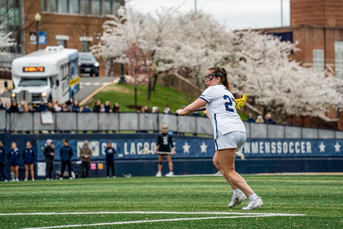 Senior attacker Grace Curry runs down the field during Friday's game against VCU.