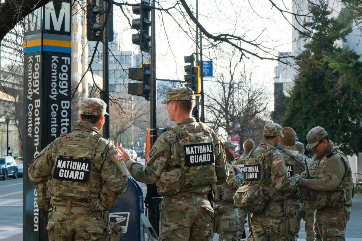 Members of the National Guard stand outside the Foggy Bottom Metro Station. 