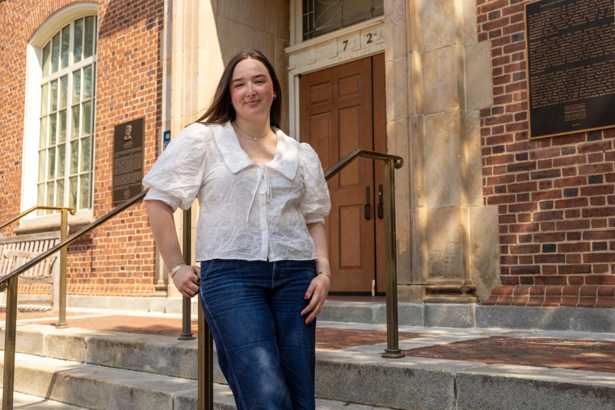 Emma Walther poses for a portrait in front of Corcoran Hall.