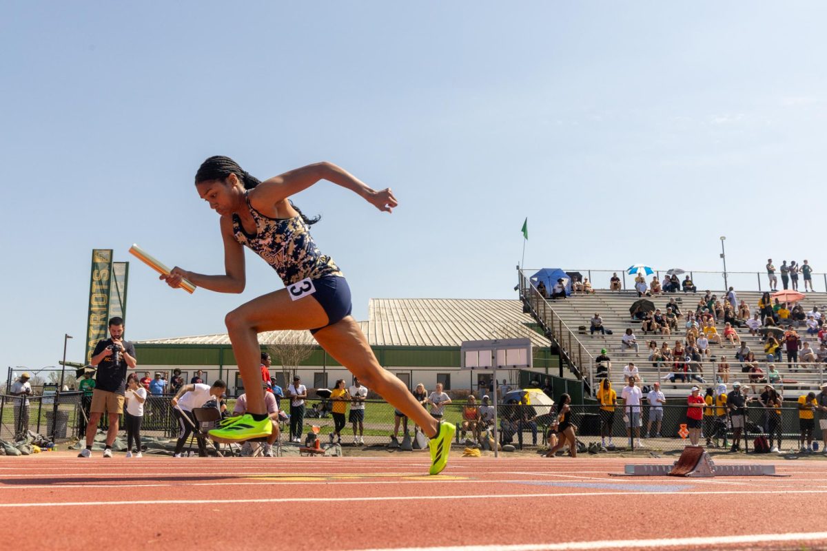 A track athlete starts off the block during a race on Saturday. 