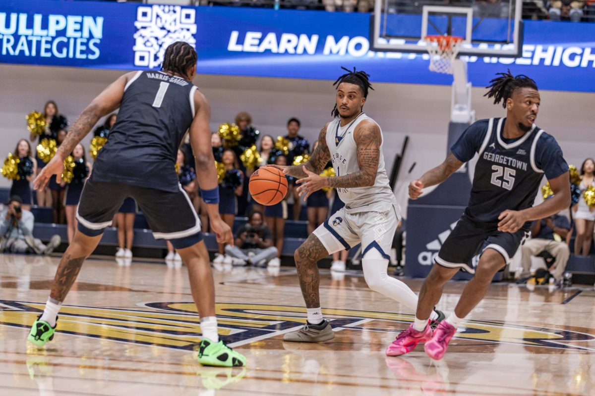 Redshirt senior guard Trey Moss dribbles during an exhibition game against Georgetown last October.