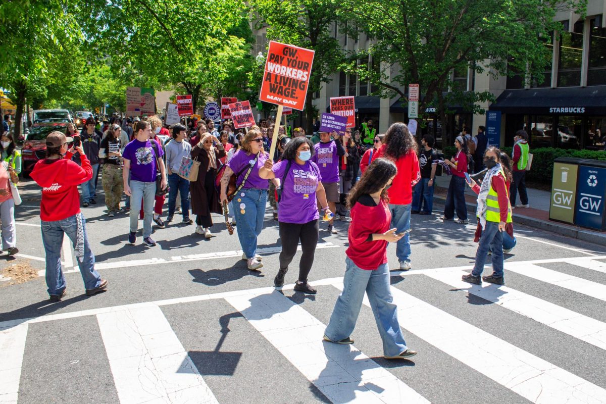 Protesters march down H St during a rally on May Day. 