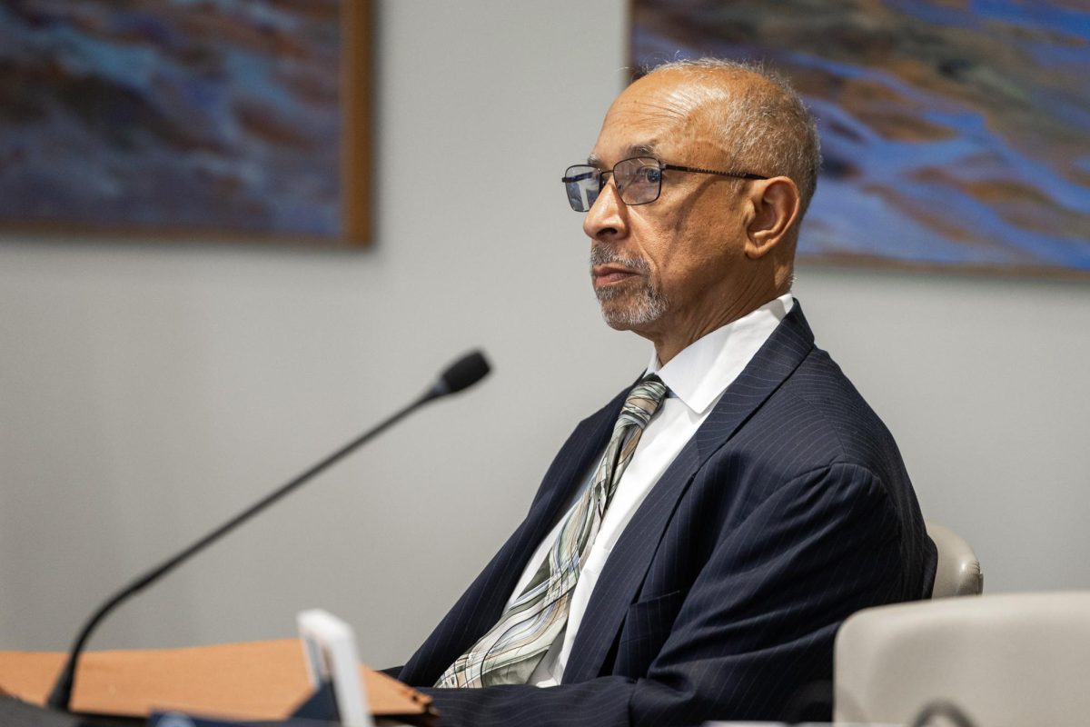 Vice President and General Counsel Charles Barber sits at Friday's Board of Trustees meeting.