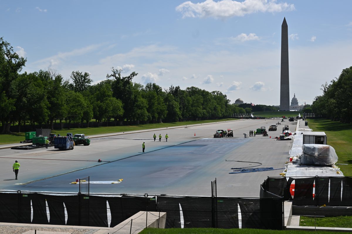 Workers carry out renovations on the drained Reflecting Pool in late April.