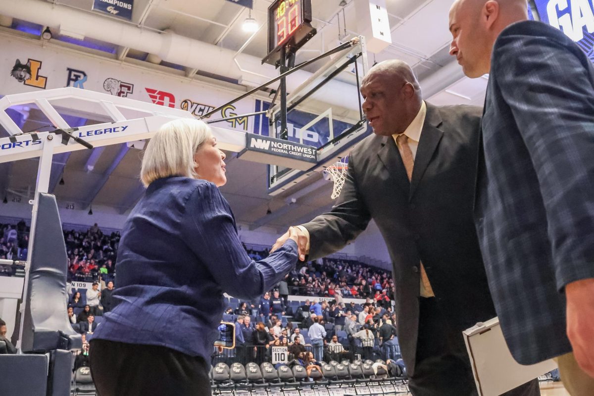 President Ellen Granberg welcomes honoree and former forward/center Mike Brown at his jersey ceremony during a men's basketball game against Dayton in February. 