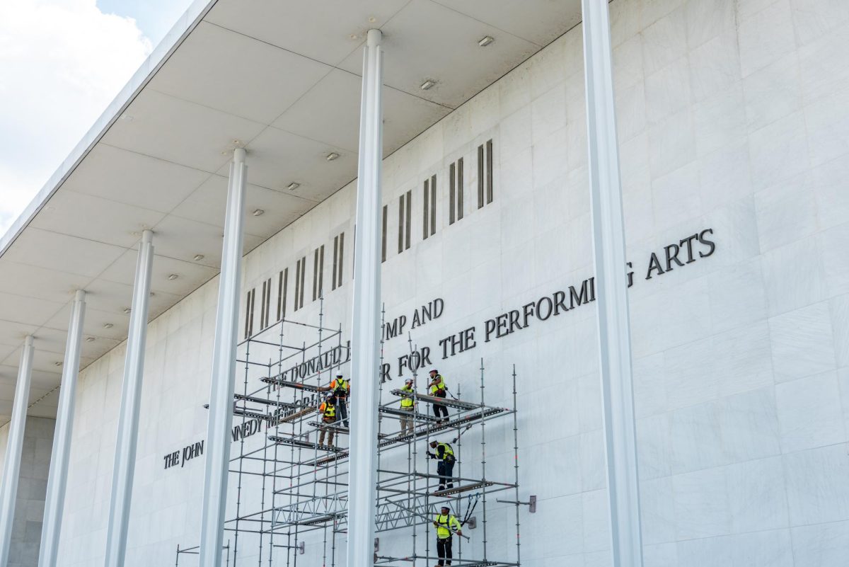 Construction crews building scaffolding to remove President Donald Trump's name from the Kennedy Center Friday. 