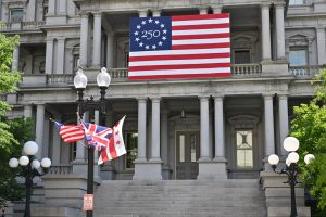 An American 250 flag hangs on the Eisenhower Executive Office Building in April.