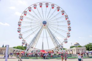 People line up to ride the Ferris Wheel at the Great American State Fair.